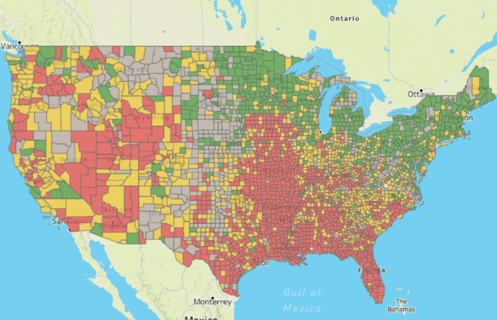 Red, green, and yellow color coded map of the United States showing higher areas of covid-19